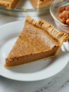 A slice of pinto bean pie served on a white plate.