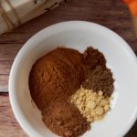 The spices for the mix in a white bowl.