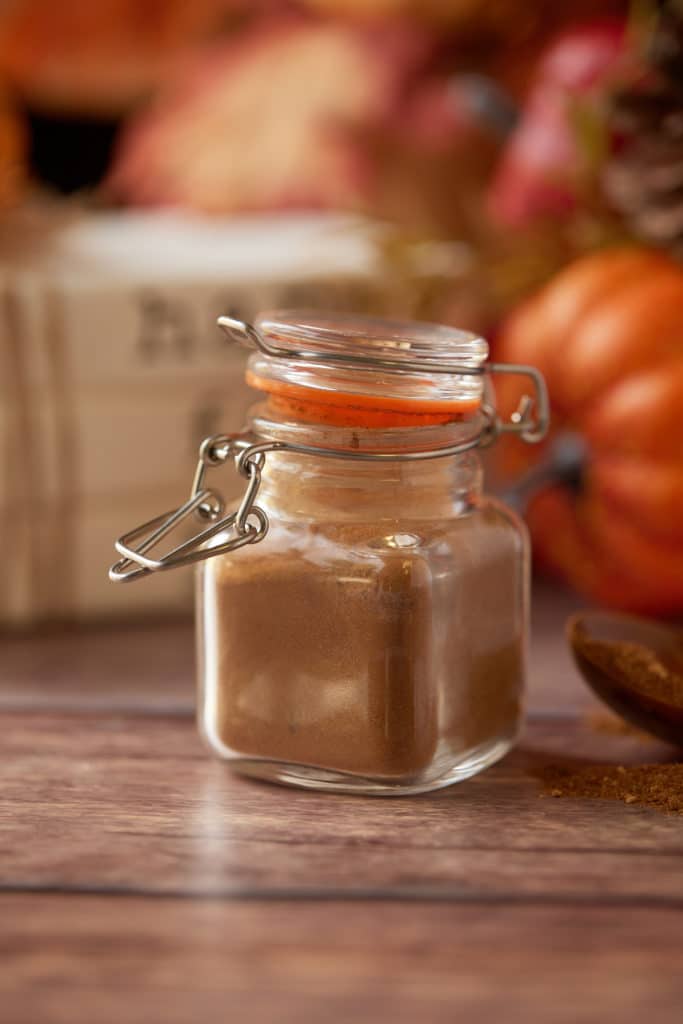 Pumpkin pie spice in a small glass jar.