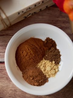 The spices for the mix in a white bowl.