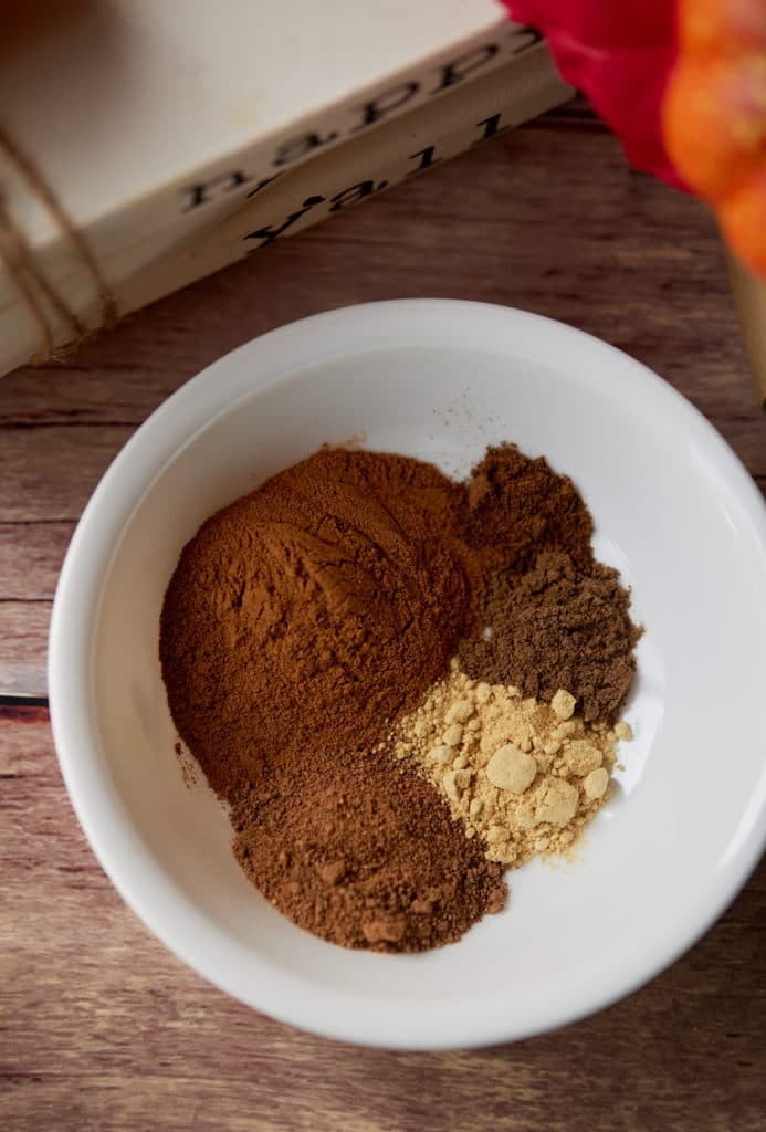 The spices for the mix in a white bowl.