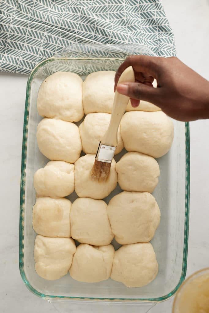 butter being spread on raw dough