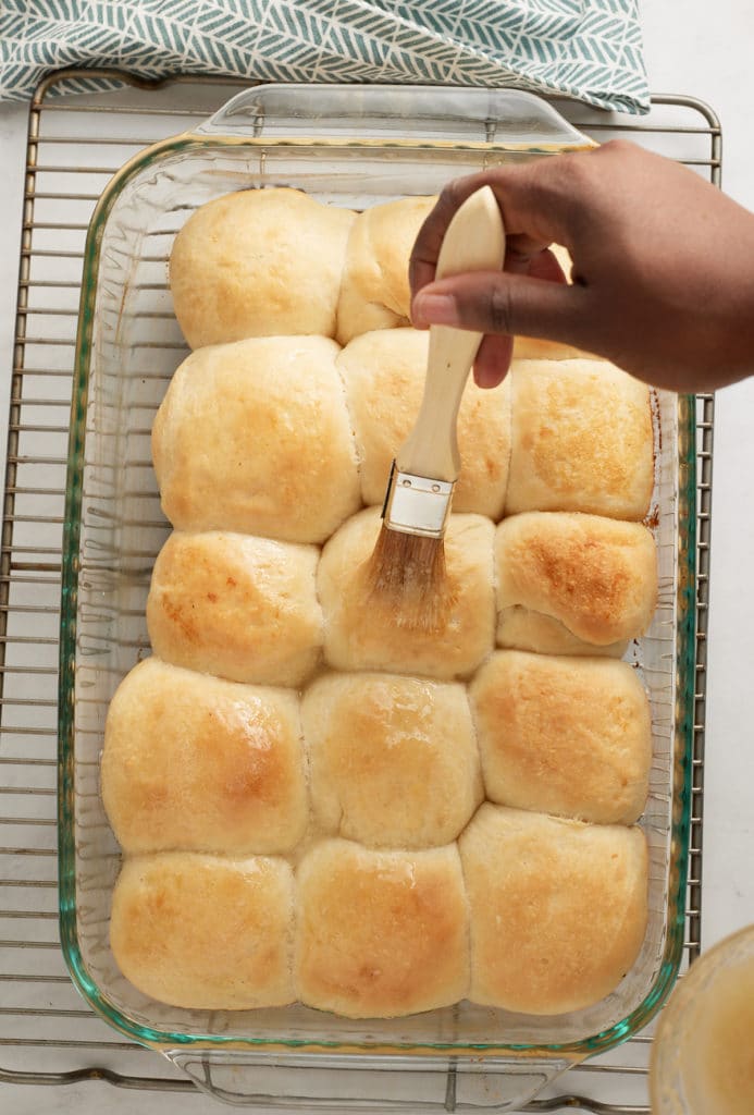 finished rolls with more butter being spread