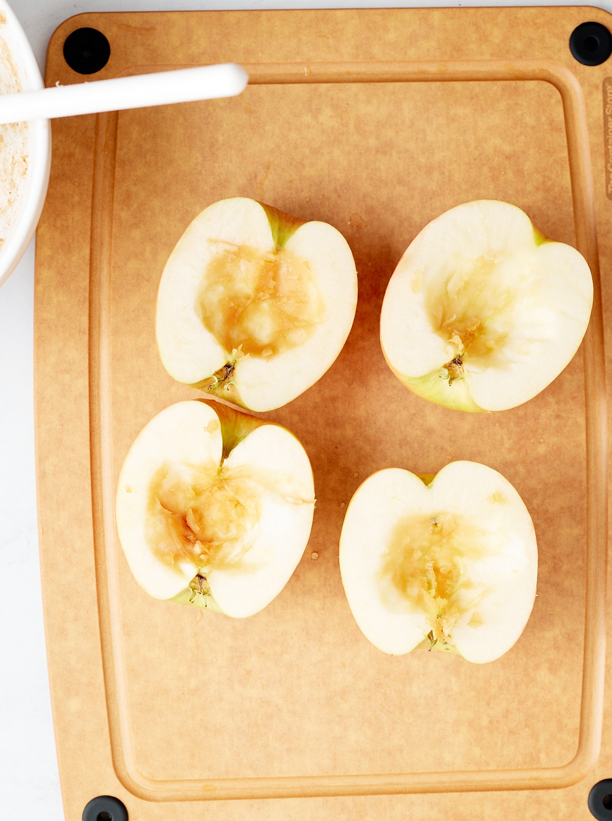 Two apples cut in half with the cores removed.