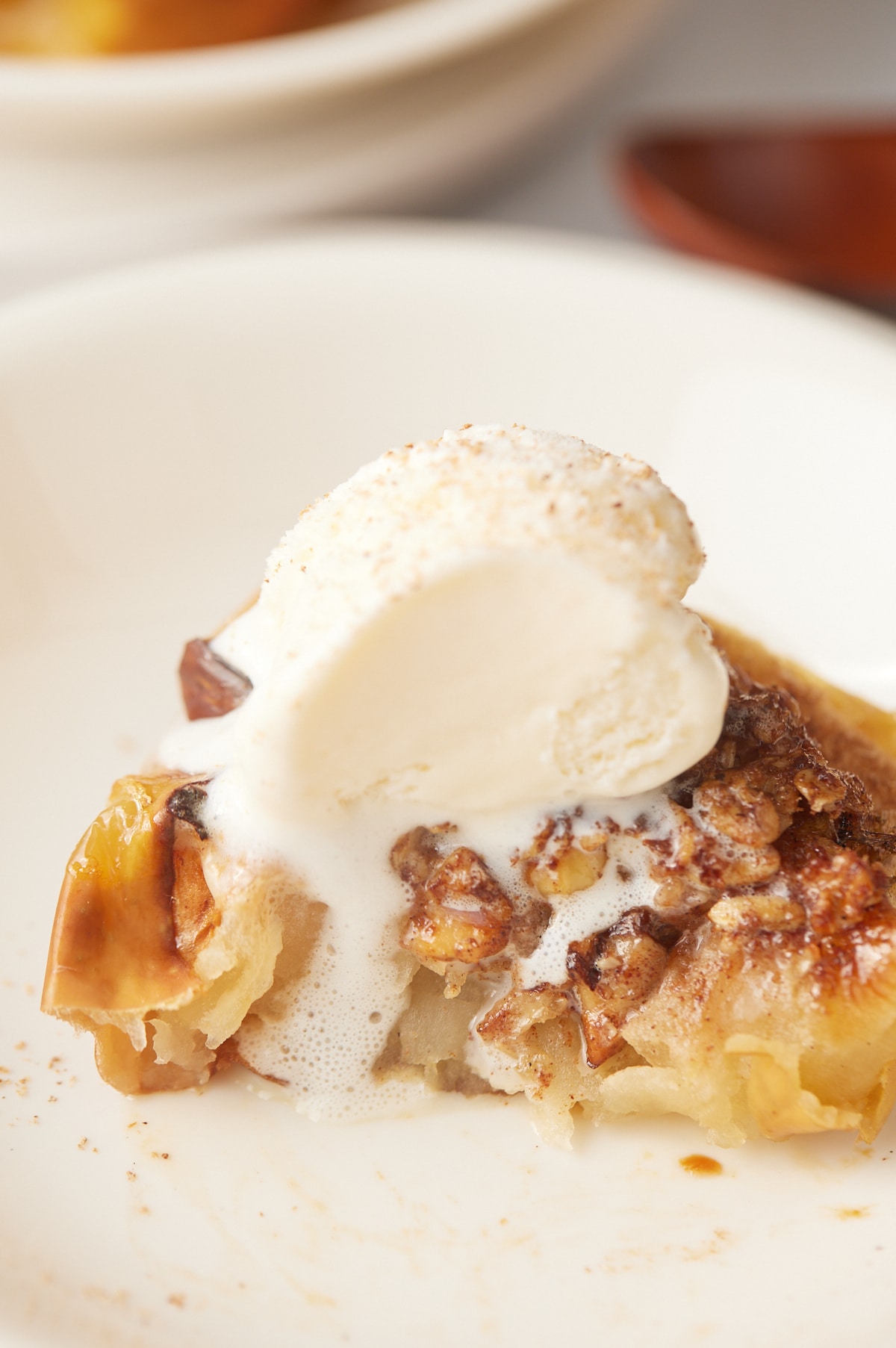 Ice cream melting over a baked apple.