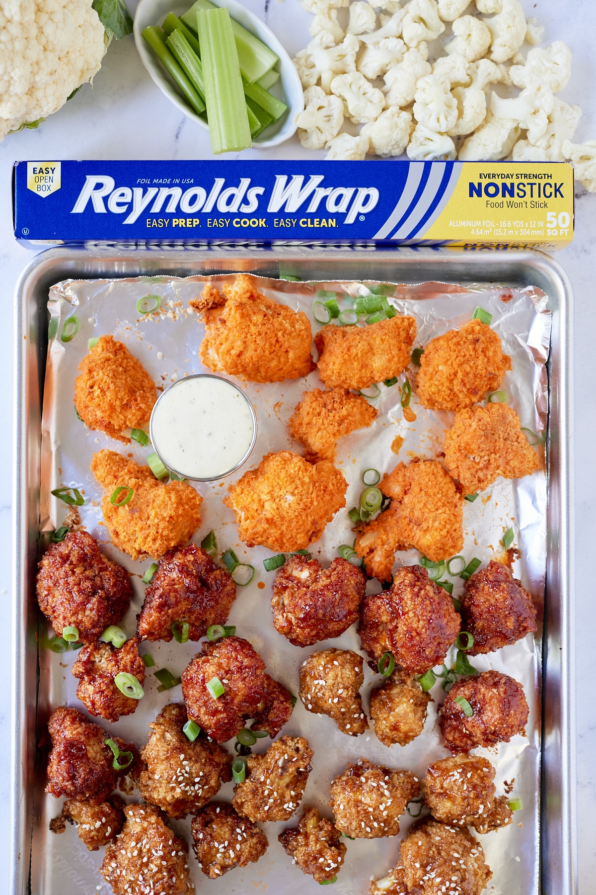 cauliflower wings on sheet pan lined with reynolds wrap foil paper