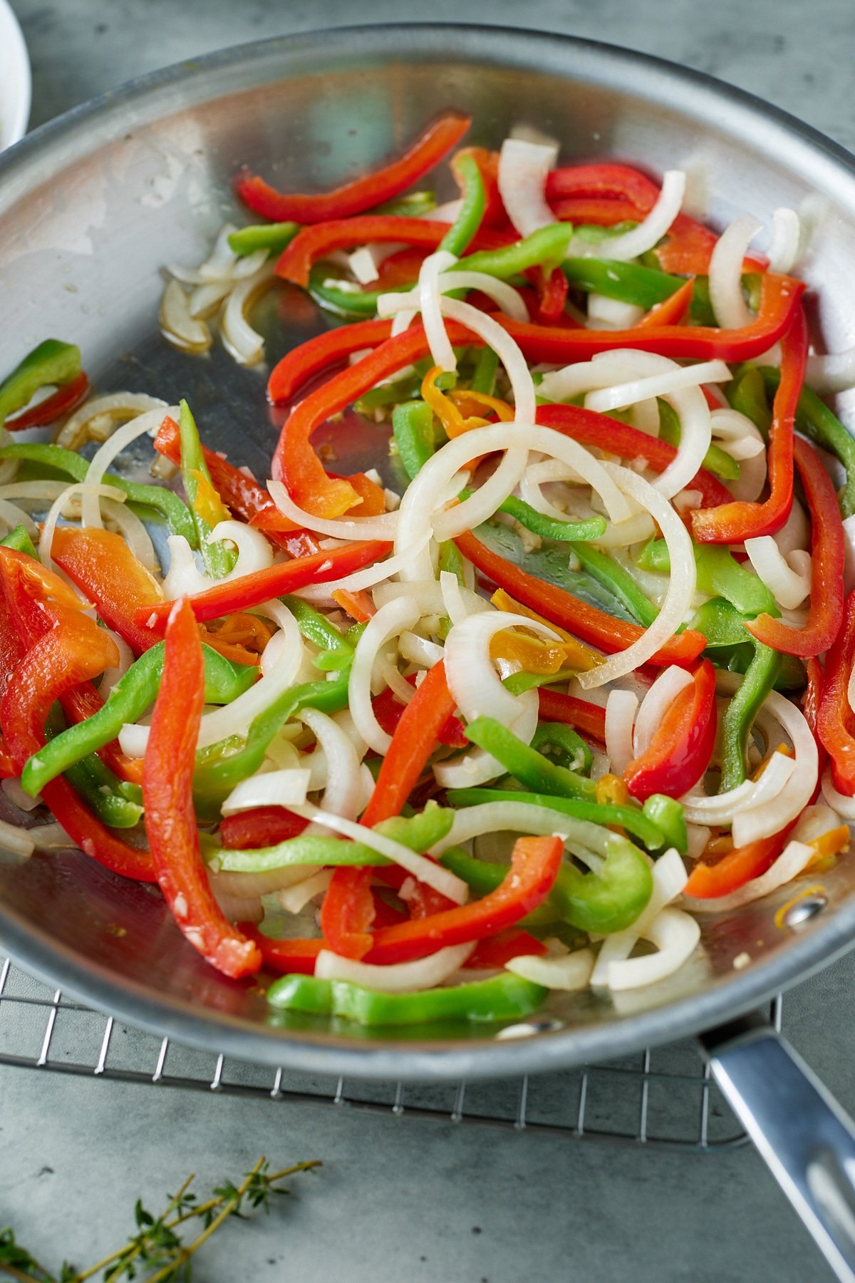 peppers, onions, and garlic in skillet