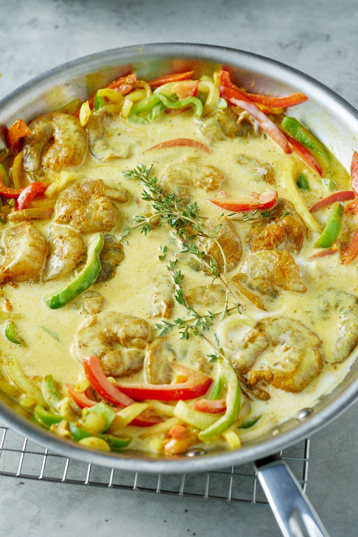 coconut milk and shrimp in skillet cooking