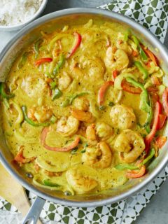 curry shrimp in the pan it was cooked in with rice on the side