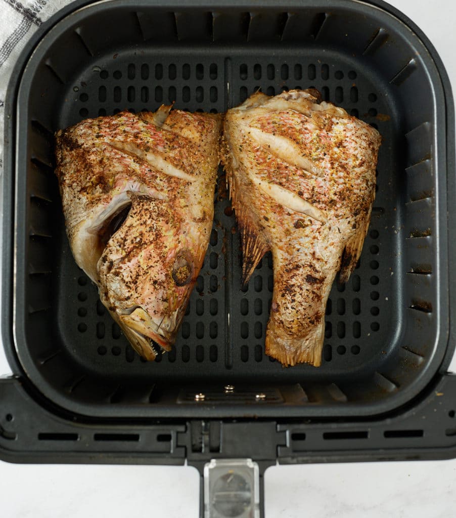 cooked fish filet in air fryer basket