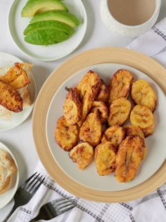 Air fryer plantains served on a white plate.