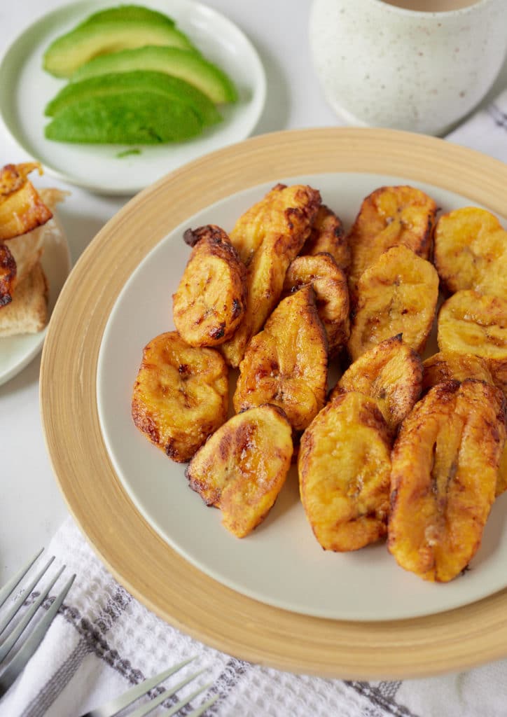 The cooked plantains served on a white plate.