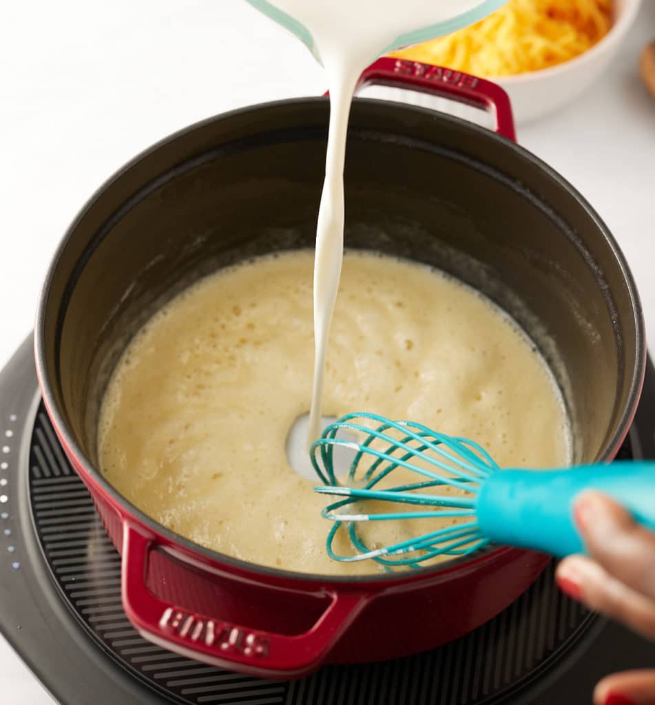 Pouring in the milk.