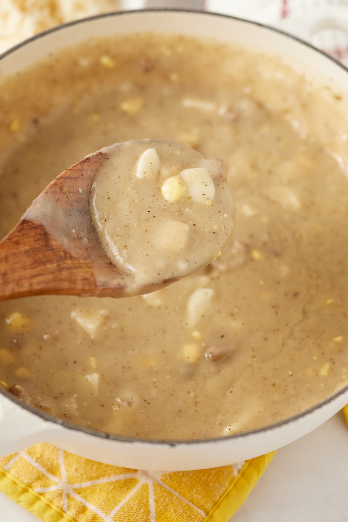 Close up of the giblet gravy on a wooden spoon.