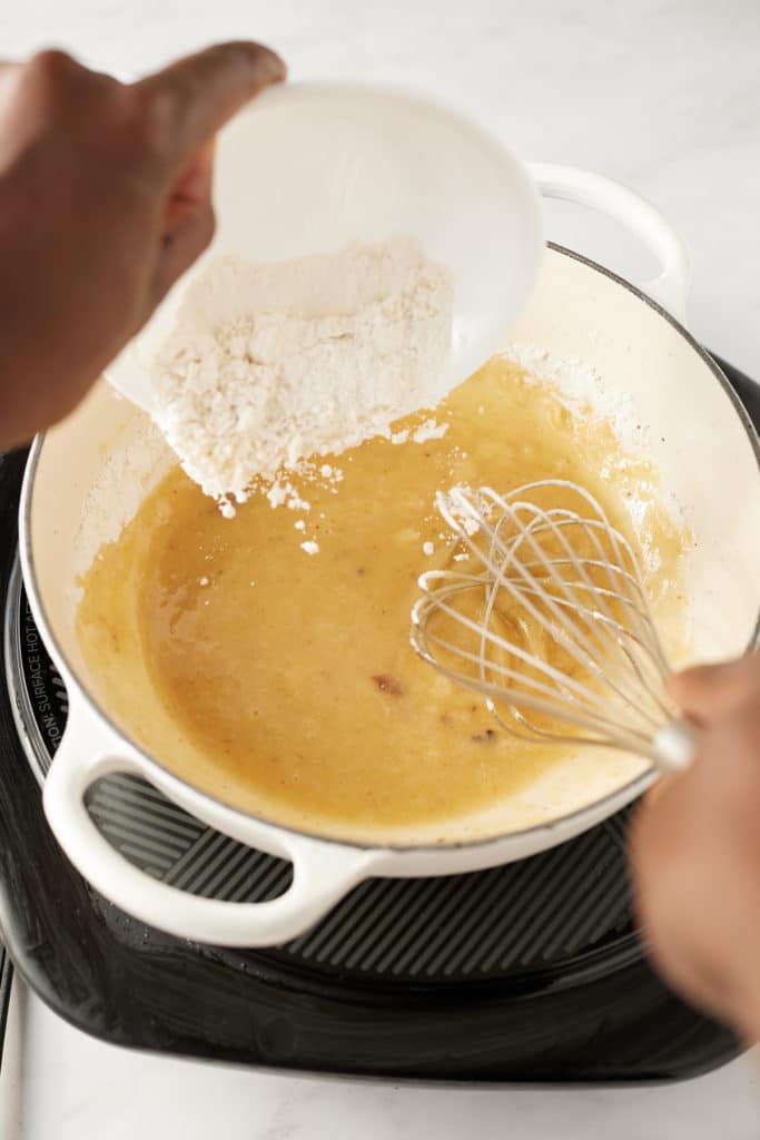 Flour being whisked into the pan.