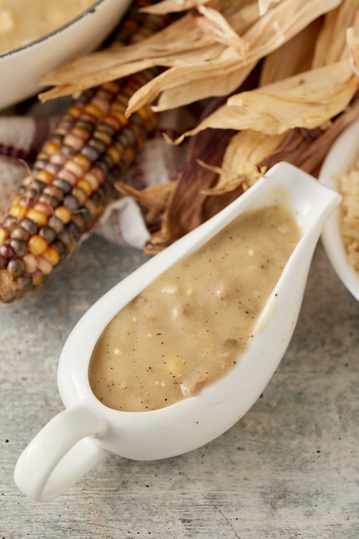 Giblet gravy served in a white gravy boat.