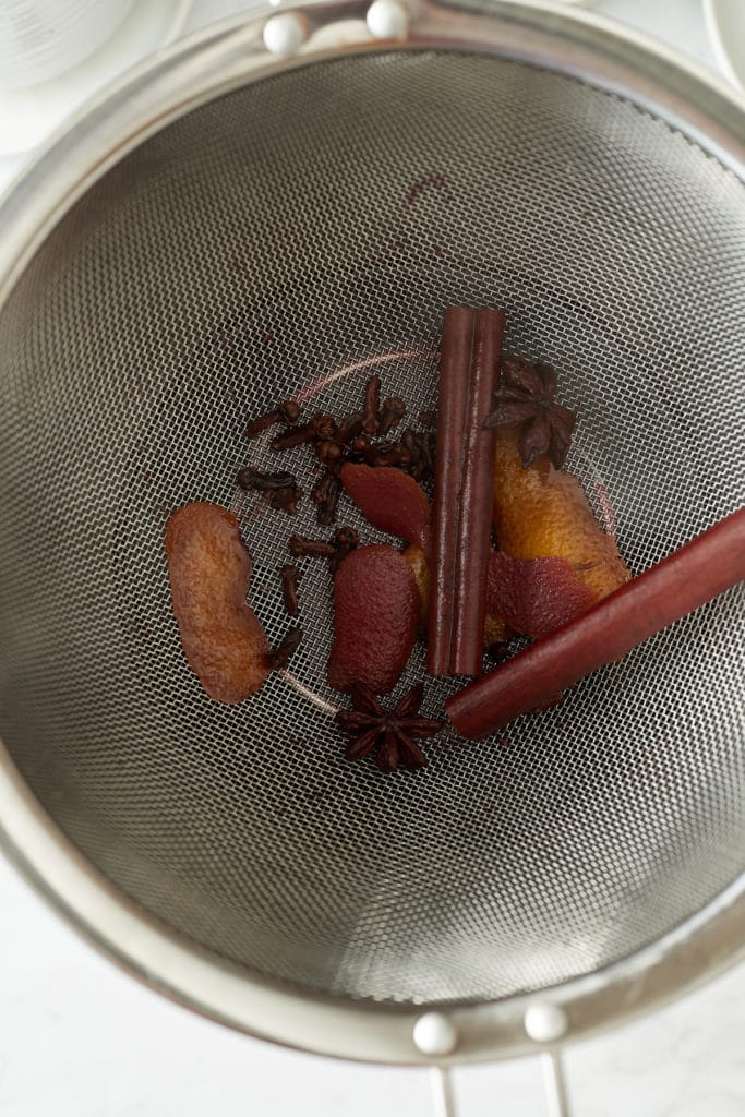 The strained spices and orange peel.