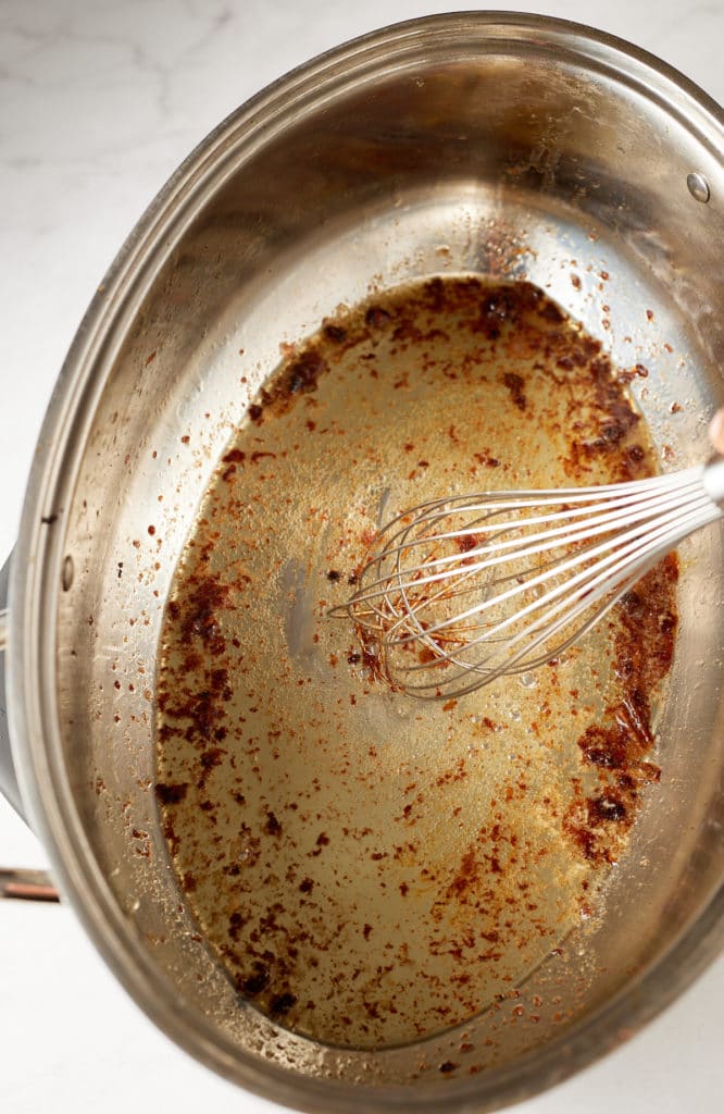 Whisking together the butter and the drippings.