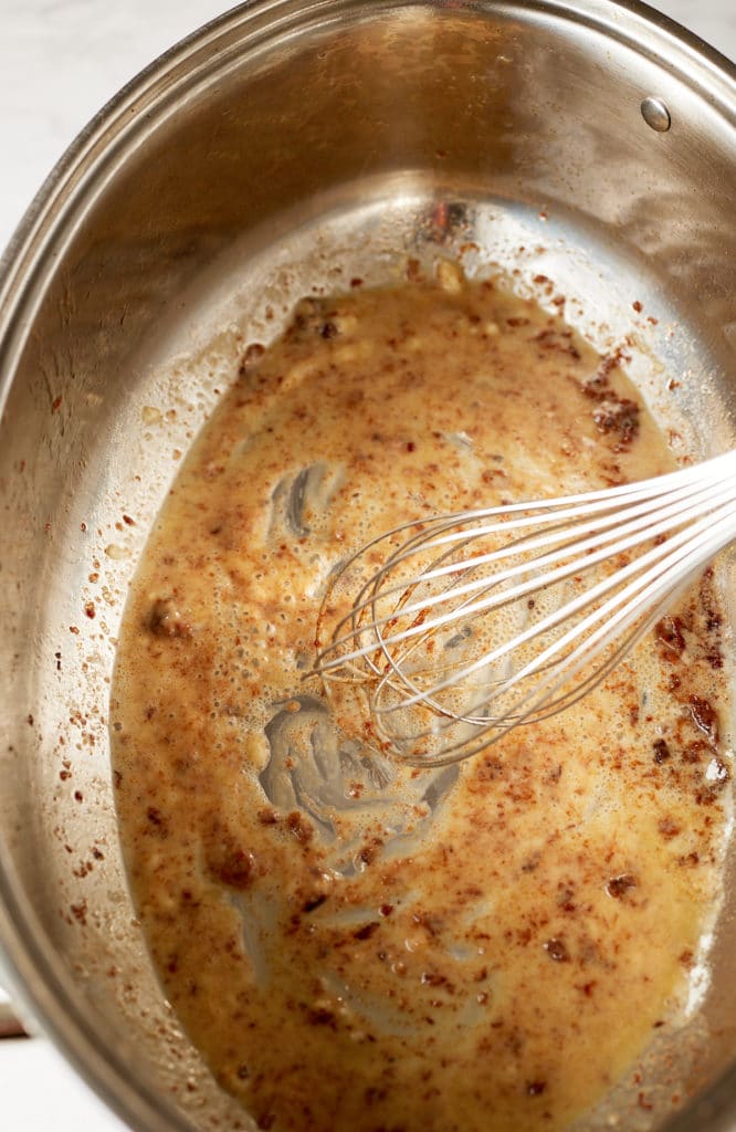 Flour being whisked in.