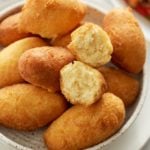 fried festival dough in plate with one broken to see inside