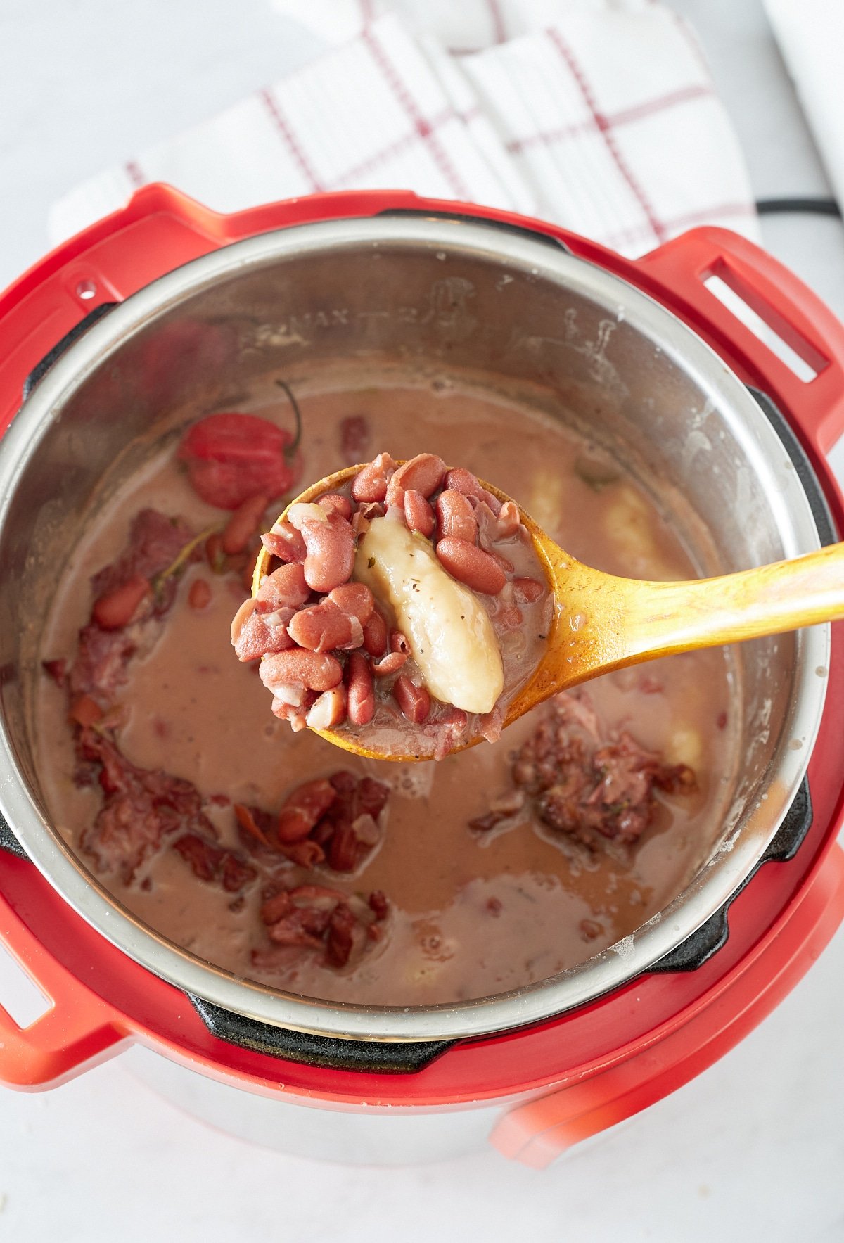 spoon holding up kidney beans with spinner on top