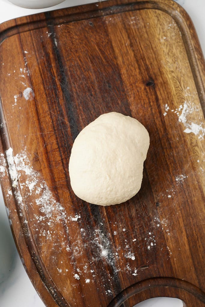 The bread dough rolled into a ball.