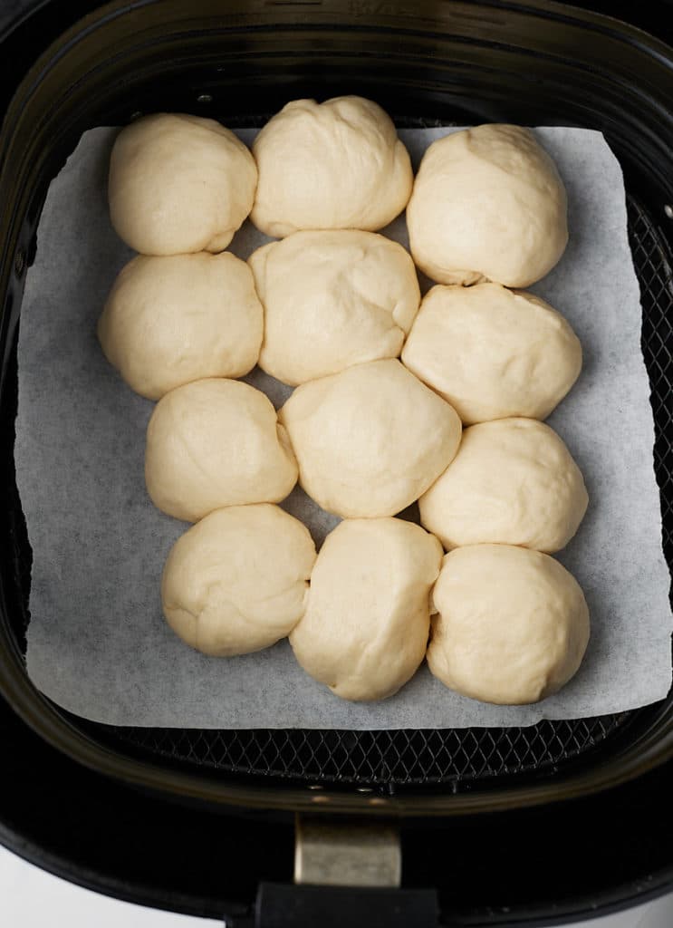 The dinner roll dough resting in the air fryer basket.