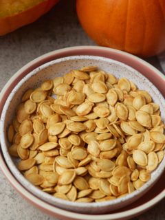 pumpkin seeds with pumpkin in background