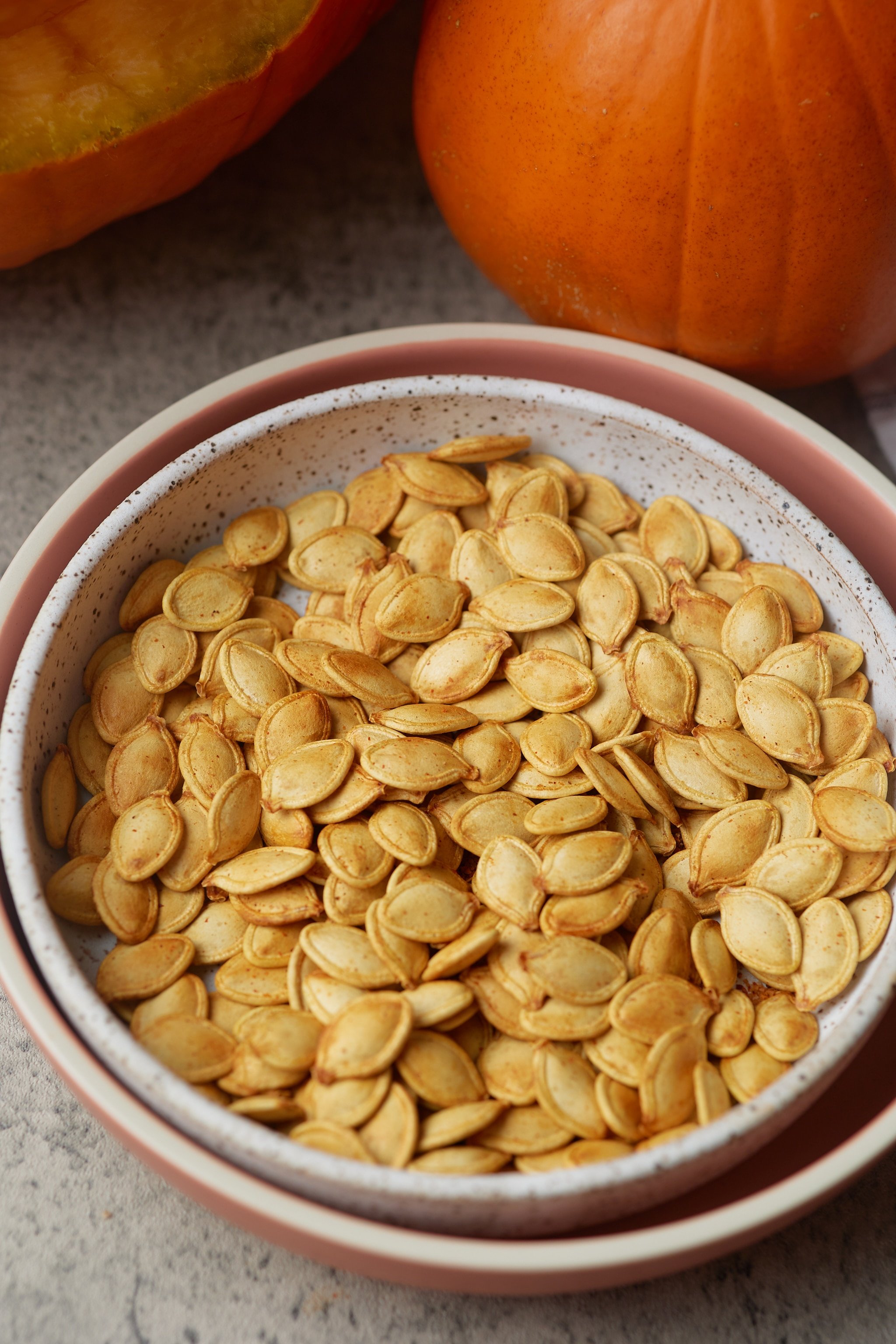 pumpkin seeds with pumpkin in background