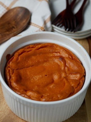 The baked carrot souffle in a large white dish.