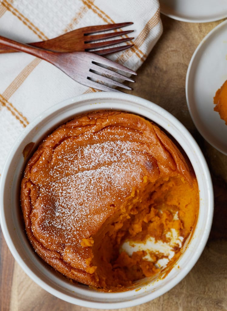 A carrot souffle topped with powdered sugar.