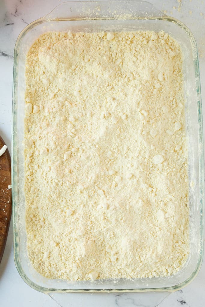 Cake mix on top of the pineapple and cherries.