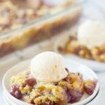 Cherry pineapple dump cake served on a plate with ice cream.