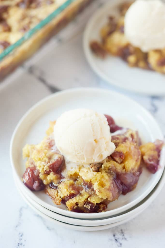 A scoop of ice cream on top of the dump cake.