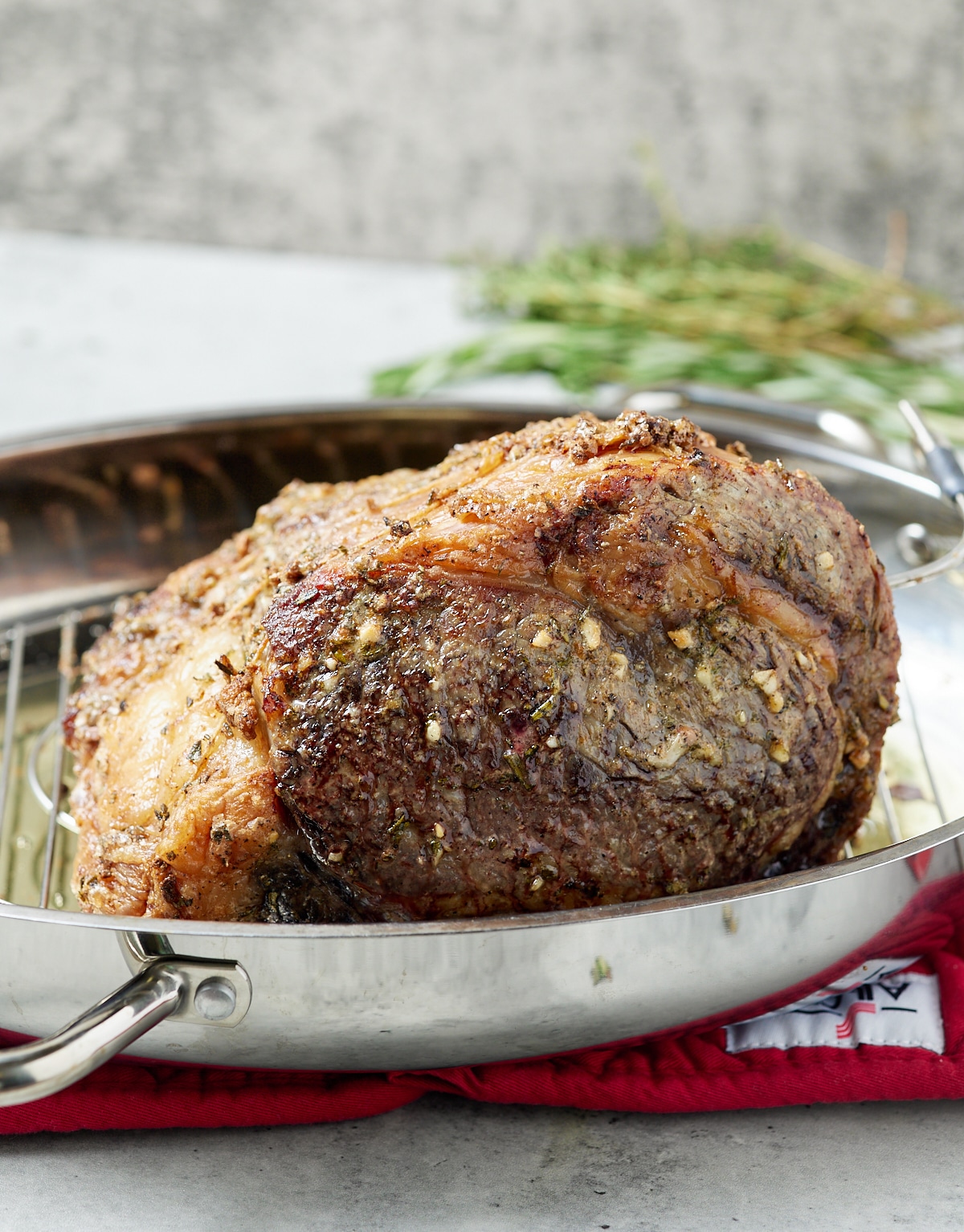 A boneless beef roast in a silver skillet.