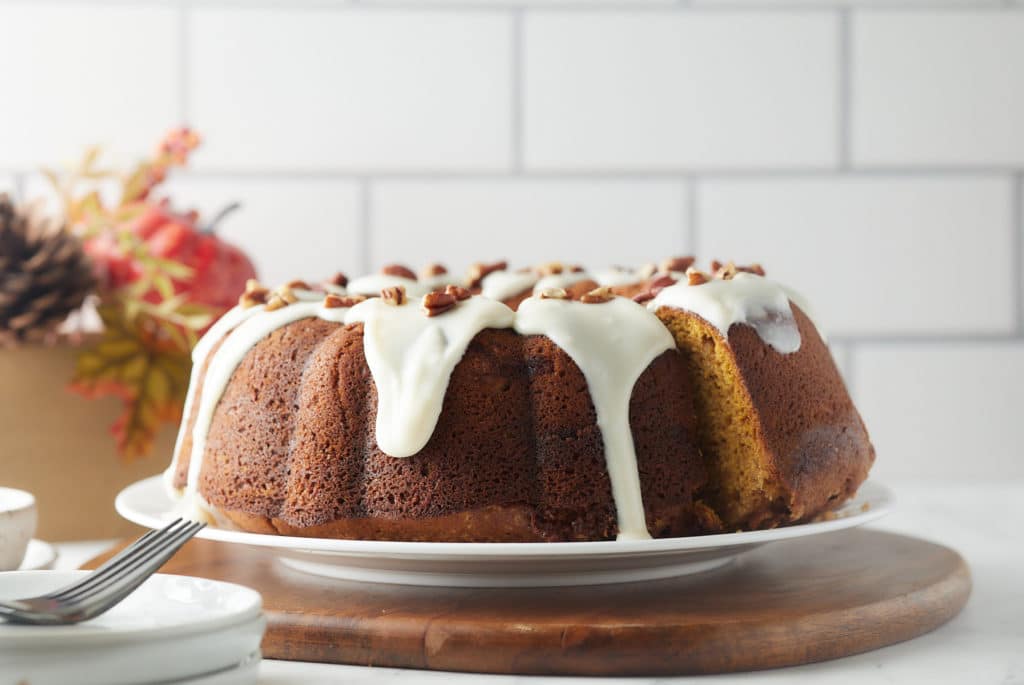 Sweet potato bundt cake with glaze served on a plate.