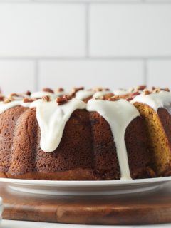 Sweet potato bundt cake with glaze served on a plate.