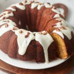 Sweet potato bundt cake with a slice cut out of it.