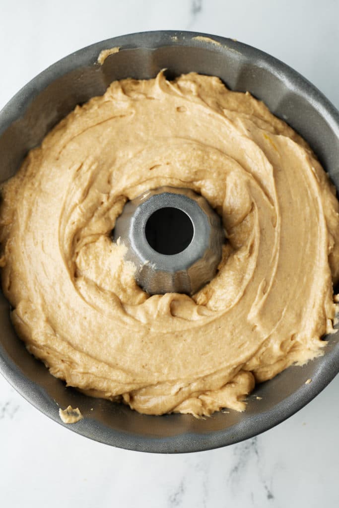 The cake batter in a bundt tin.