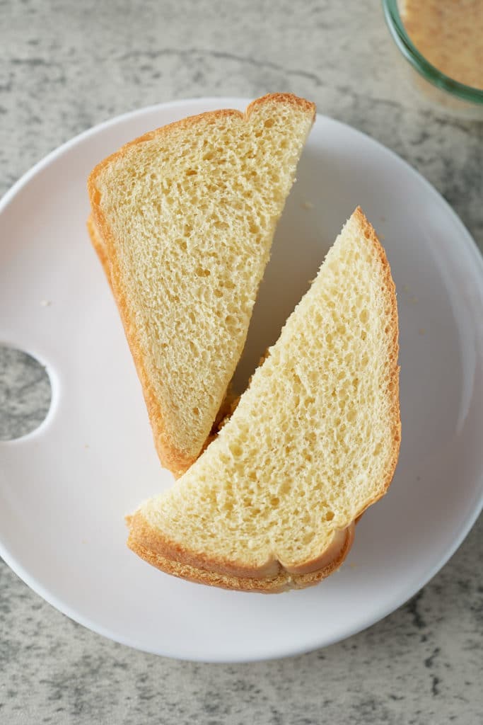 Brioche bread slices cut in half.
