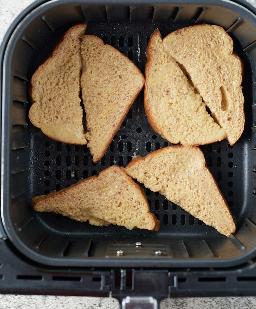 Slices of egg coated bread in the air fryer.