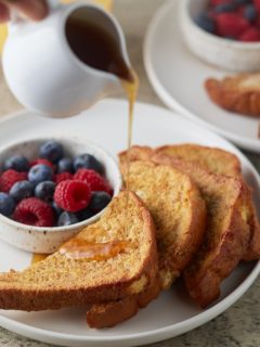 Maple syrup being poured over slices of air fried French toast.