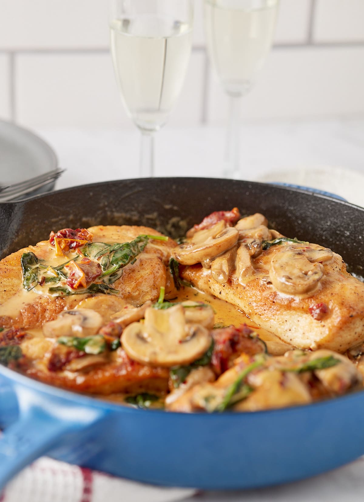 Cooked champagne chicken in a skillet on a worktop.