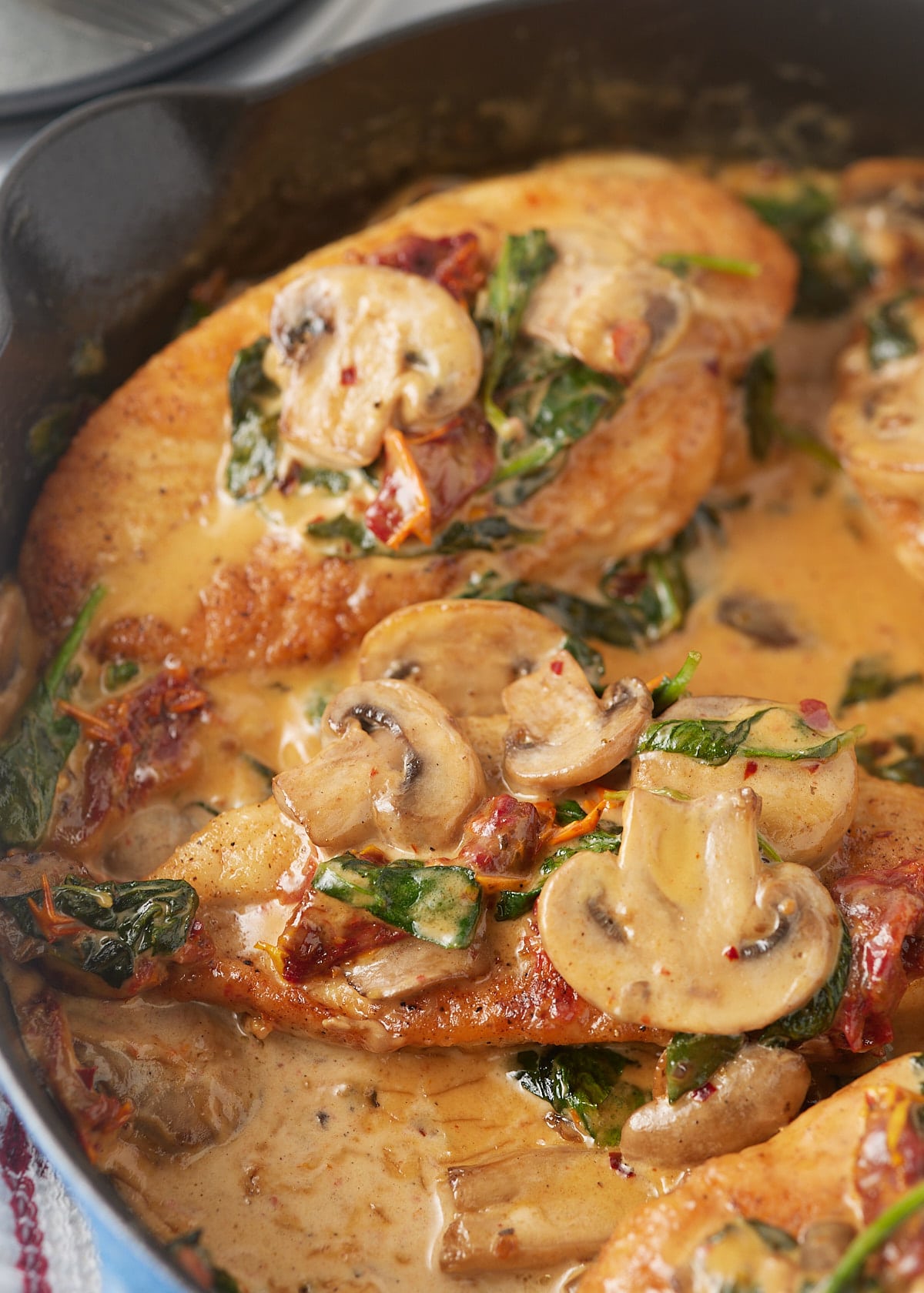 Close up of sliced mushrooms on the chicken breast.