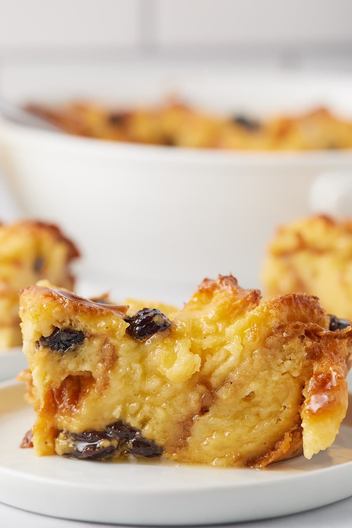 A piece of eggnog bread pudding served on a plate.