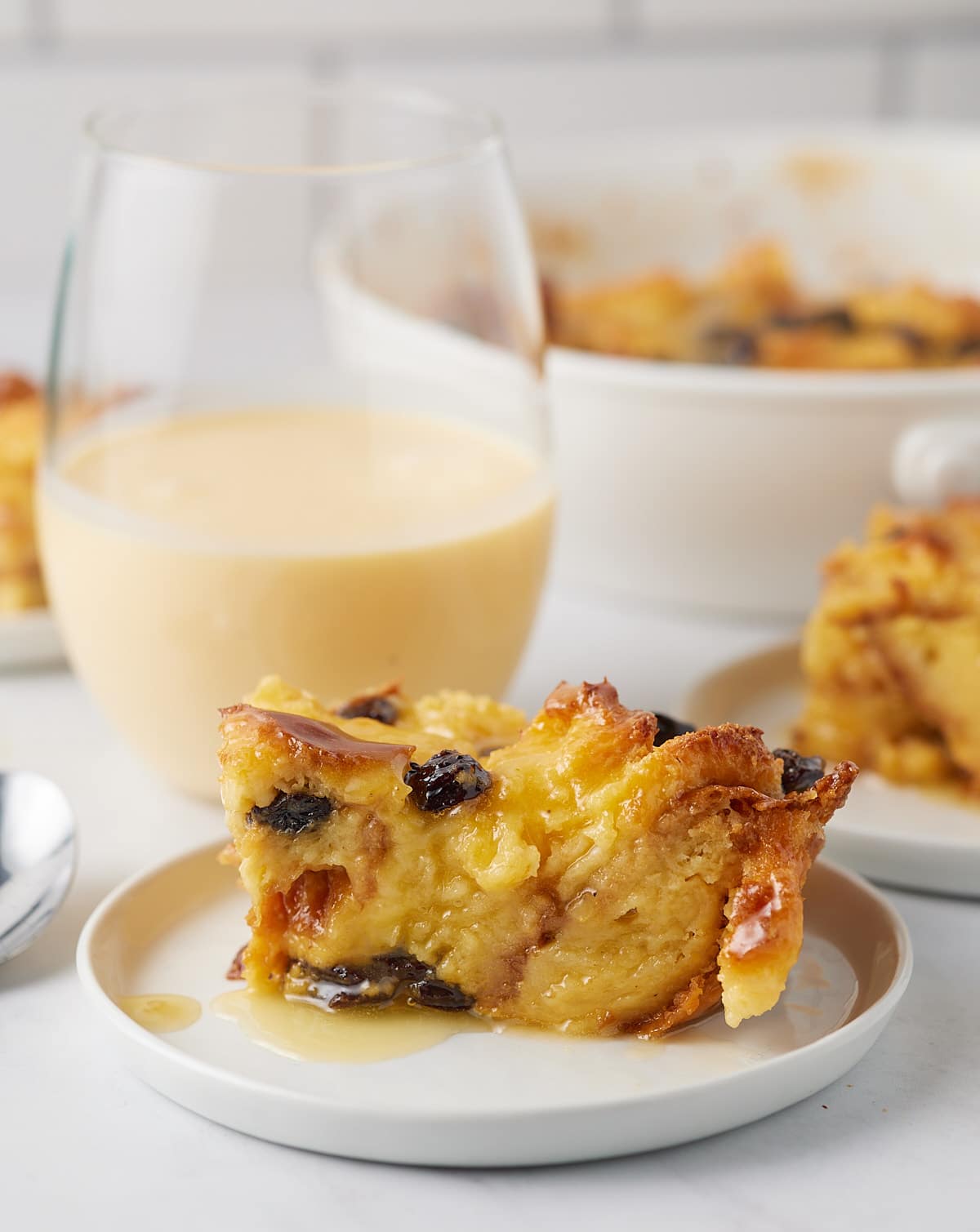 Eggnog bread pudding served on a white plate.