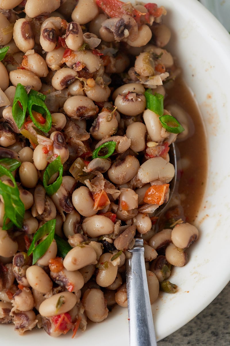 Close up of the cooked beans in a white bowl.