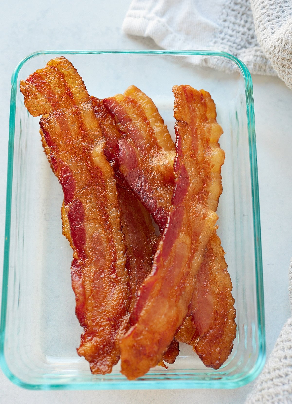 Strips of bacon in a storage conatiner.