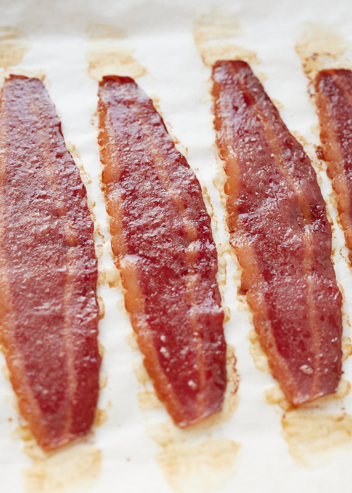 Close up of three bits of cooked turkey bacon.