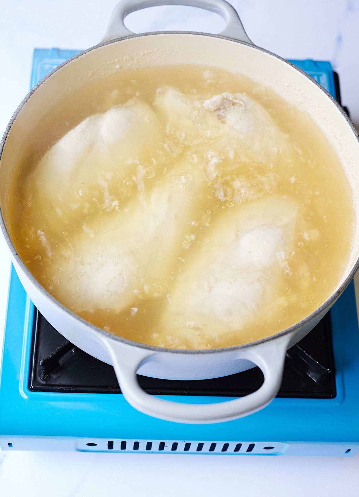 chicken breast boiling in chicken broth